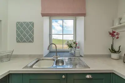 a kitchen with a sink and a window at Erw-Dinmael in Corwen