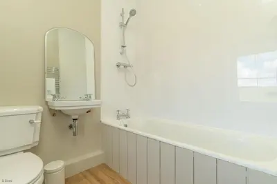 a bathroom with a tub and a sink and a toilet at Erw-Dinmael in Corwen