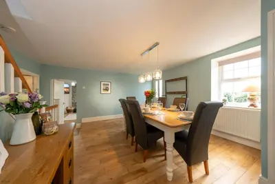 a dining room with a table and chairs at Isgoed in Talsarnau