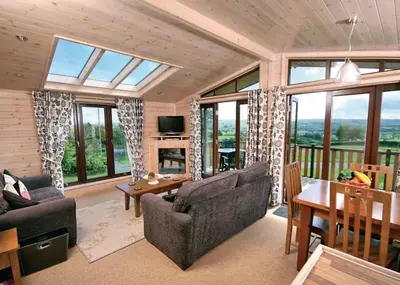 a living room with a couch and a table at Belan Bach Lodges in Towyn