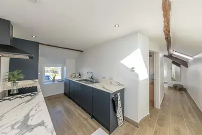 a kitchen with a sink and a counter at Bwthyn-Bennar in Dyffryn