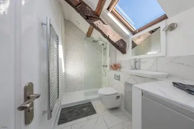 a bathroom with a toilet and a sink and a window at Bwthyn-Bennar in Dyffryn
