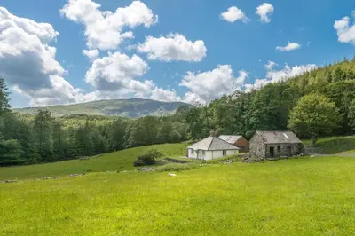 an old house in a field in a grassy field at Maes-Y-Coed in Dolgellau