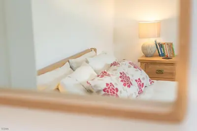 a reflection of a bed with pillows in a mirror at Maes-Y-Coed in Dolgellau