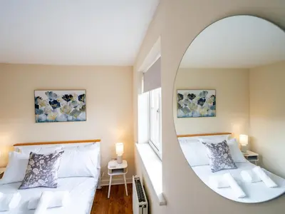 a bedroom with a mirror and a bed at Pass the Keys 3 Bedroom home local to Ludlow town centre in Ludlow