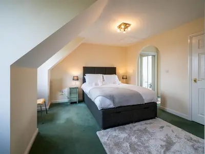 a bedroom with a large bed and an attic at Pass the Keys 3 Bedroom home local to Ludlow town centre in Ludlow