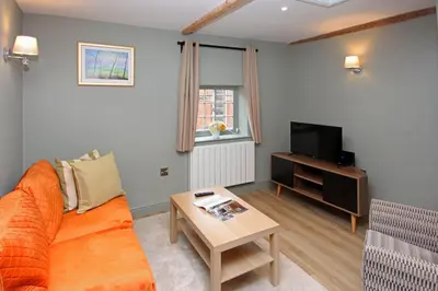 a living room with a couch and a table at St John's Hill Apartments in Shrewsbury