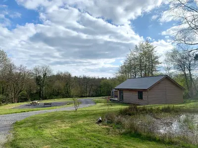 a small building in a field next to a road at Dwrgi in Llanybydder