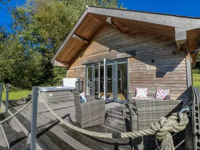 a small cabin with a rope around the deck at Dwrgi in Llanybydder