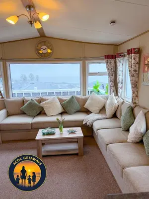 a living room with a couch and a table at Preselli 5- Quay West Holiday Park, New Quay in New Quay