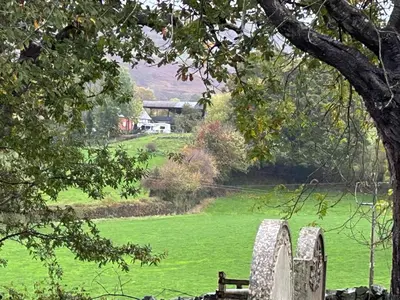 a cemetery with a bench in a green field at Hyssington Heights in Hyssington