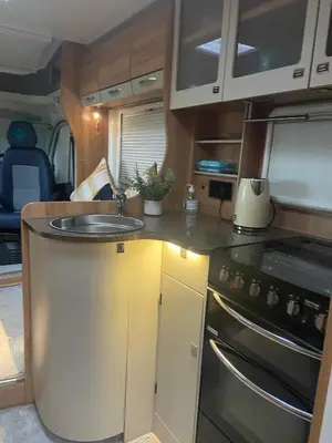 a kitchen with a sink and a stove in an rv at Hyssington Heights in Hyssington