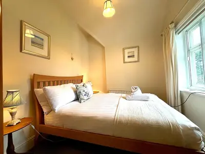 a bedroom with a bed and a window at Spacious 4-Bed Home - Oswestry - Families & Groups in Oswestry