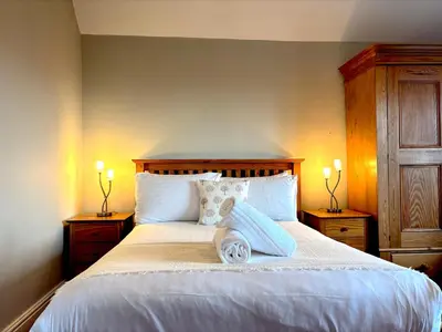 a bedroom with a large bed with two night stands at Spacious 4-Bed Home - Oswestry - Families & Groups in Oswestry