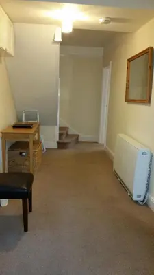 an empty room with a radiator and a table at High Mead - family house with spectacular views in Aberdyfi