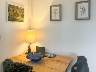 a room with a wooden table with a lamp and a table sidx sidx at Archers Cottage in Leominster