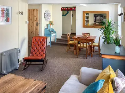 a living room with a couch and a table at Kookaburra Lodge in Brecon