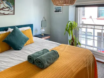 a bedroom with a bed with two towels on it at Kookaburra Lodge in Brecon
