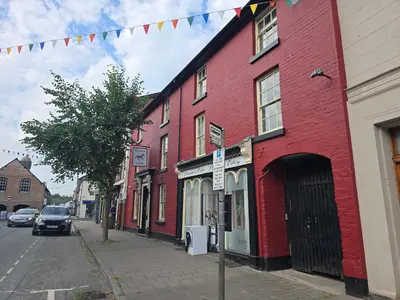 a red building on the side of a street at Twin room - The Unicorn Hotel in Llanidloes