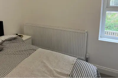 a bedroom with a bed and a window at Llangollen - House - Sleeps 8- Garden in Llangollen