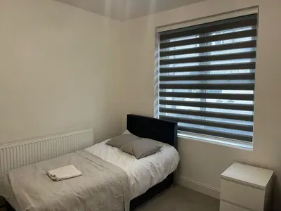 a small bedroom with a bed and a window at Llangollen - House - Sleeps 8- Garden in Llangollen
