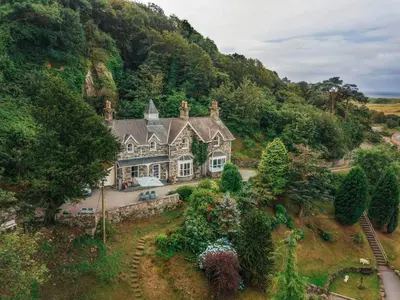 an aerial view of a house in the mountains at Noddfa Country House in Harlech