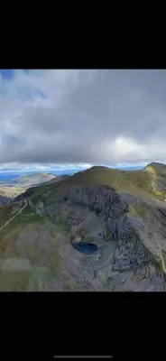 an aerial view of a mountain with a lake on it at Serene Llanbedr Retreat with Garden View in Llanbedr