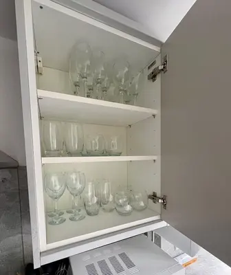 a cabinet filled with wine glasses on shelves at Charming 2 bedroom cottage in Brecon - families and pets welcome! in Brecon