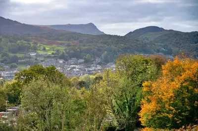 a town in the hills with mountains in the background at Finest Retreats - Pandy Mongolian Yurt in Dolgellau