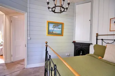 a bedroom with a bed and a chandelier at Finest Retreats - Waen Fechan in Dolgellau