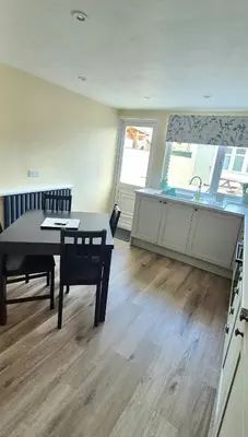 a kitchen and dining room with a table and a sink at Amaryllis Escapes in Brecon