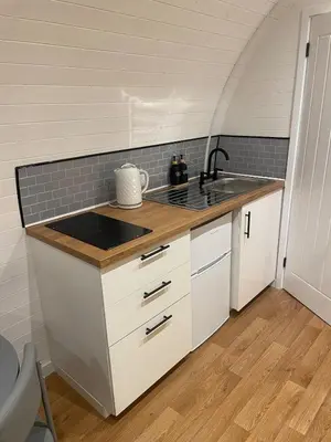 a kitchen with a sink and a counter top at AfonCoed - A cozy, quiet stay by the river in Llanrhaeadr-ym-Mochnant