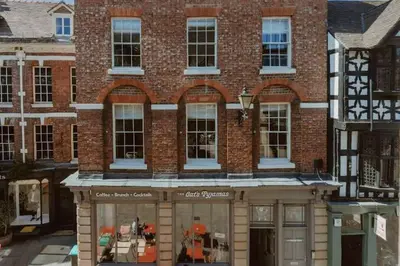 a brick building with a store in front of it at The Catnap Suite in Shrewsbury