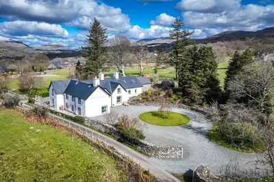an aerial view of a white house with a pond at Cefn-Y-Maes in Dolgellau
