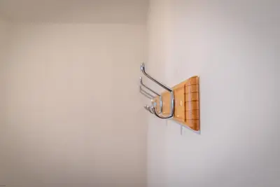 a towel rack on a wall with a wooden object at Hafan-Glan-Mor in Barmouth