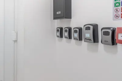 a door with four cell phones on a wall at Hafan-Glan-Mor in Barmouth