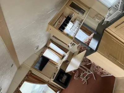 an overhead view of a living room with chairs and a kitchen at Lyons Sunnysands - Sandy Cove 50 in Llanddwywe