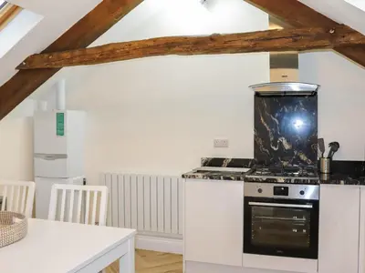 a kitchen with a stove and a counter top at Apartment One - Uk49591 in Bala