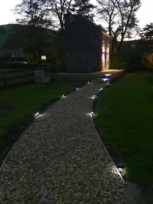 a walkway in front of a house with lights at The Hand at Llanarmon in Llanarmon Dyffryn-Ceiriog