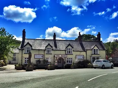 a white car parked in front of a building at The Hand at Llanarmon in Llanarmon Dyffryn-Ceiriog