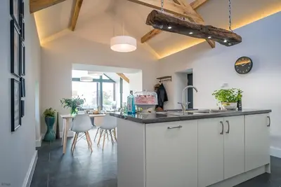 a kitchen with white cabinets and a counter top at Y-Ddol in Dyffryn