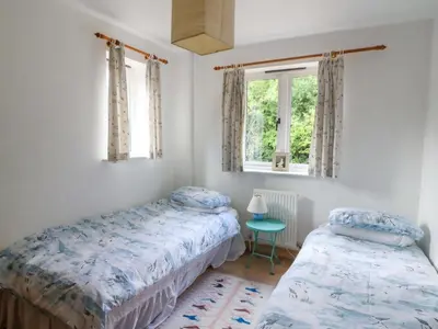 a bedroom with two beds and a window at Gaer Hall in Welshpool
