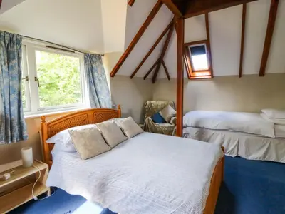a bedroom with two beds and a window at Gaer Hall in Welshpool