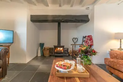 a living room with a table with a plate of food at Y-Felin in Dyffryn