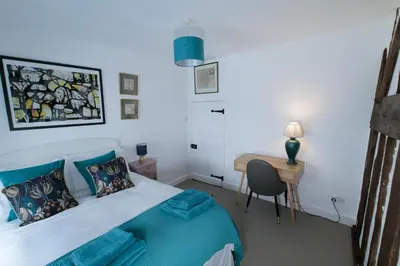 a bedroom with a bed and a desk with a chair at Pepper House Rooms - shared facilities - pet friendly in Ludlow