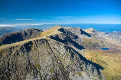 an aerial view of a rocky mountain with a lake at Faeldre in Dyffryn