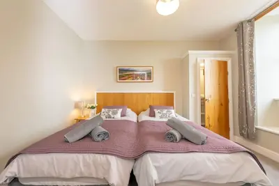 a bedroom with a large bed with two pillows at Faeldre in Dyffryn