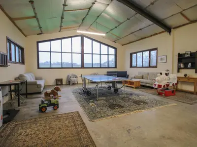 a living room with a ping pong table and toys at Upper Home Farm in Church Stretton