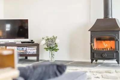 a living room with a fireplace and a tv at 1 Bed in Llangower oc-t34142 in Llangower