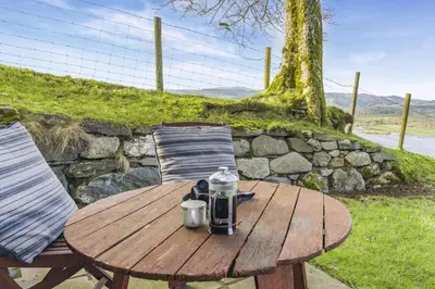 a wooden table and chairs with a coffee maker on it at 1 Bed in Llangower oc-t34142 in Llangower